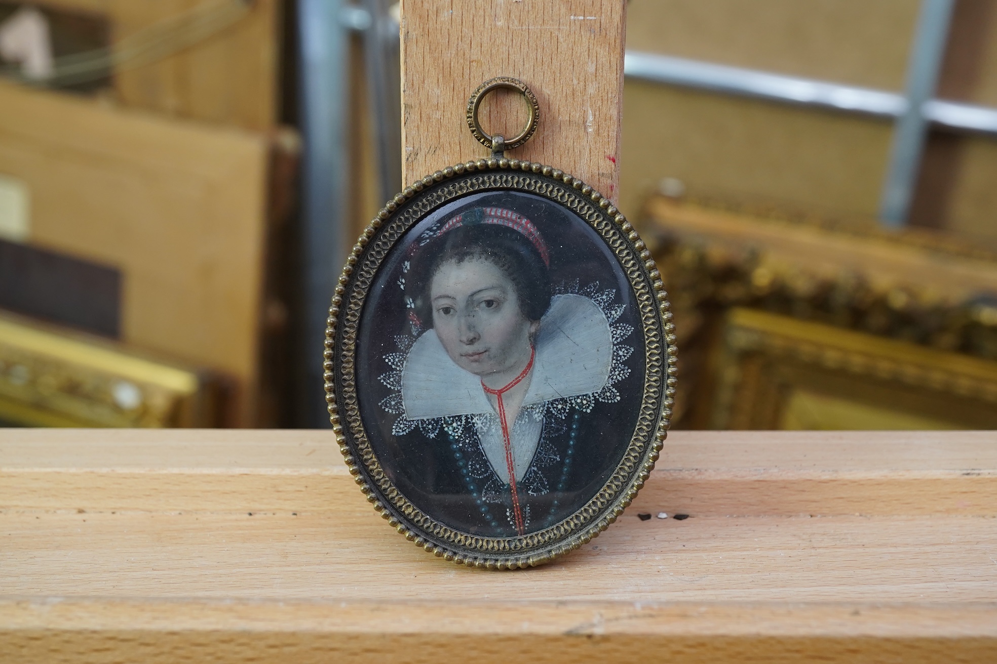 Dutch school, 17th century, A portrait miniature of a lady wearing a lace ruff and coral necklace